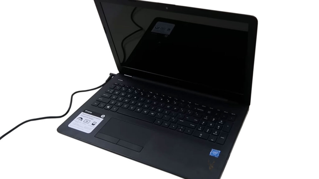 HP laptop connected to its power adapter but refusing to turn on after repeated presses of the power button.