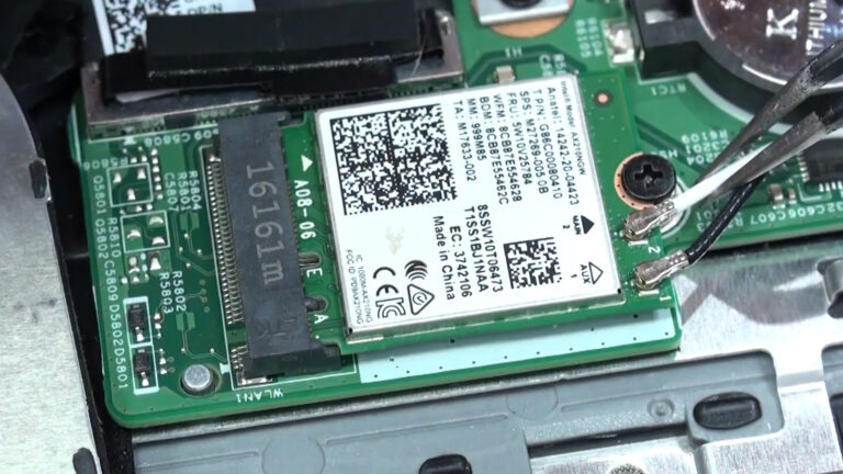 Laptop Wi-Fi card with the black and white antenna cables connected during wireless network troubleshooting.