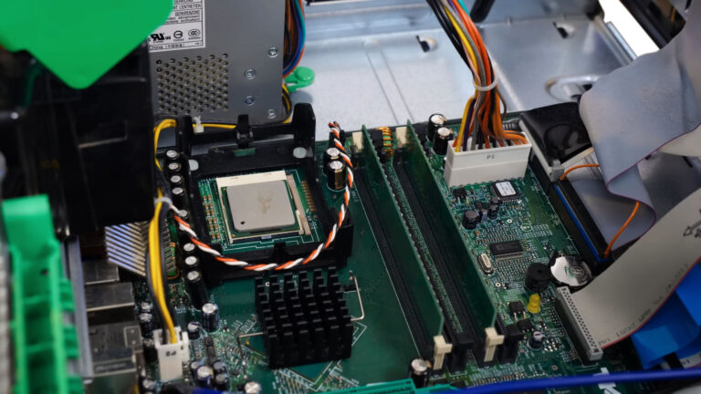 Open Dell desktop computer with the CPU air duct removed, exposing the heatsink and cooling fan for noise inspection.
